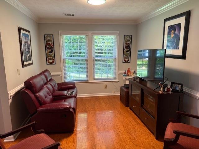 3545 Manchester Dr, Lawrenceville, GA 30044 - living area featuring light wood-style flooring and crown molding