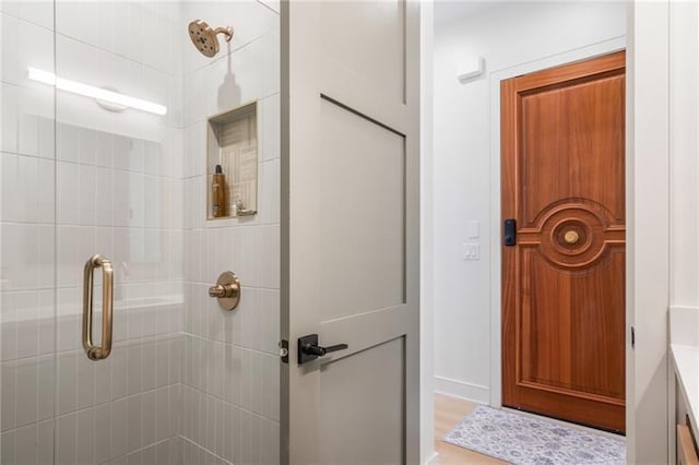 bathroom with vanity and a shower with shower door