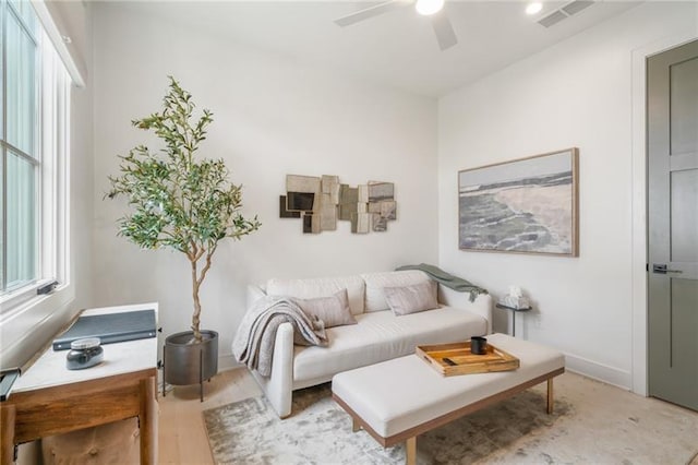 living room featuring ceiling fan and light hardwood / wood-style floors