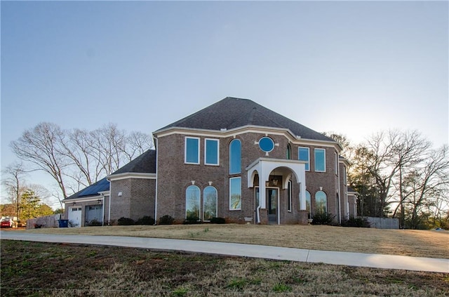 view of front of property with a garage and a lawn