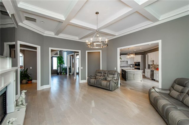 living room featuring baseboards, coffered ceiling, beamed ceiling, light wood-style floors, and a notable chandelier