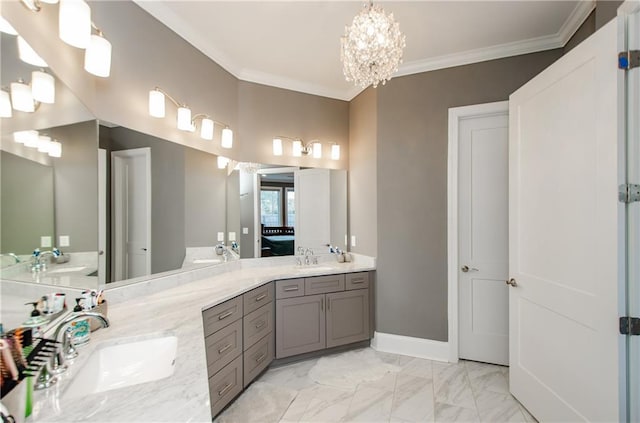 bathroom with crown molding, vanity, and an inviting chandelier