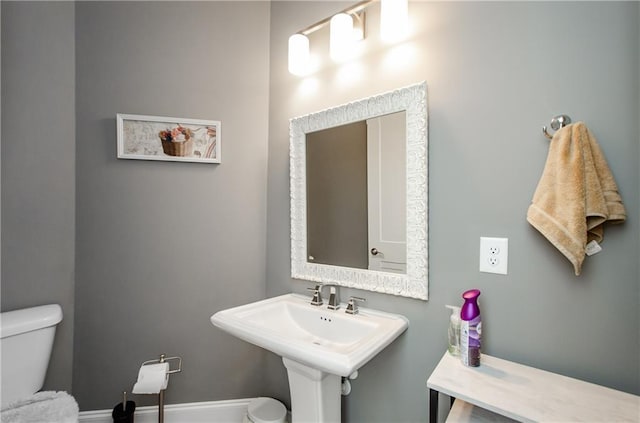 half bath featuring a sink and toilet