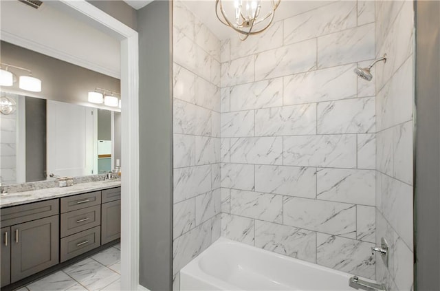 bathroom with vanity, tiled shower / bath combo, and a chandelier