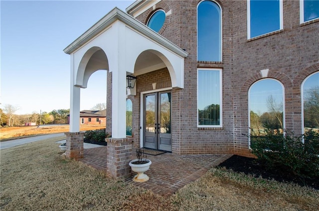 view of exterior entry with brick siding