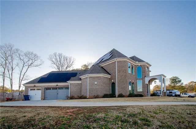 view of front of house with a garage and solar panels