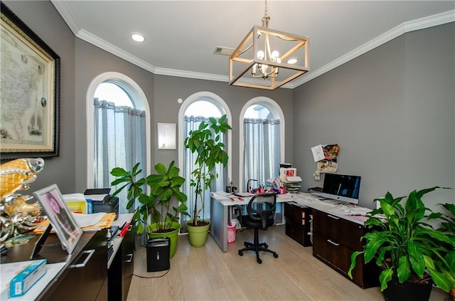 office space with light wood finished floors, visible vents, ornamental molding, and a notable chandelier