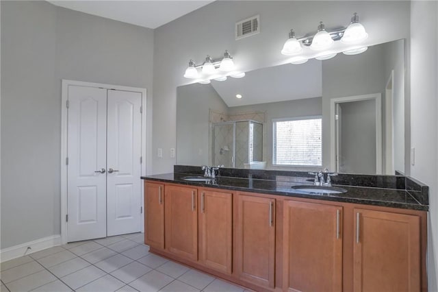 bathroom featuring vanity, vaulted ceiling, a shower with door, and tile patterned floors