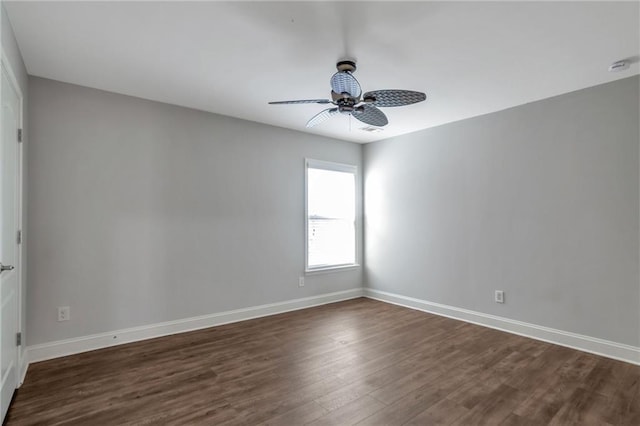 unfurnished room with ceiling fan and dark hardwood / wood-style flooring