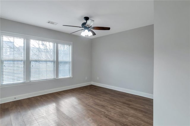 spare room with dark hardwood / wood-style floors and ceiling fan