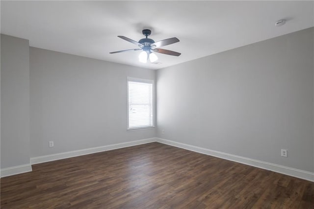 empty room featuring ceiling fan and dark hardwood / wood-style flooring