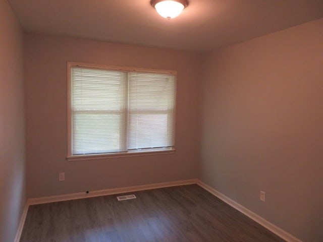 unfurnished room with hardwood / wood-style flooring