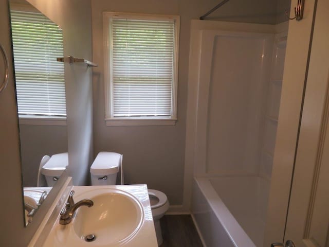 full bathroom featuring shower / bathtub combination, sink, toilet, and hardwood / wood-style flooring