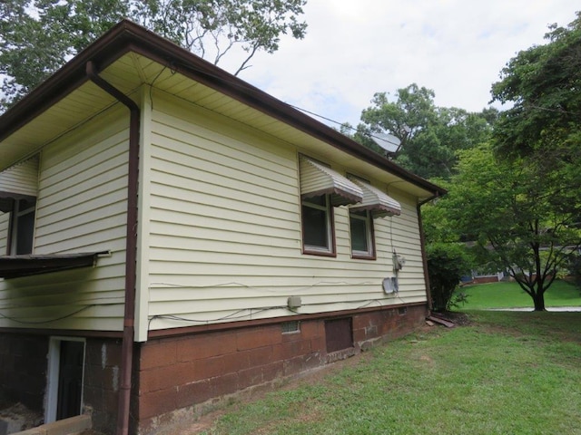 view of side of home featuring a yard