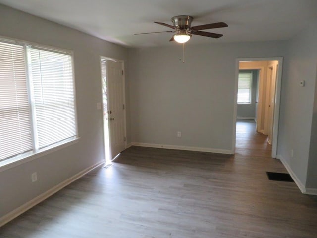 empty room with hardwood / wood-style flooring and ceiling fan