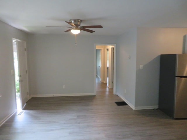 interior space with wood-type flooring and ceiling fan