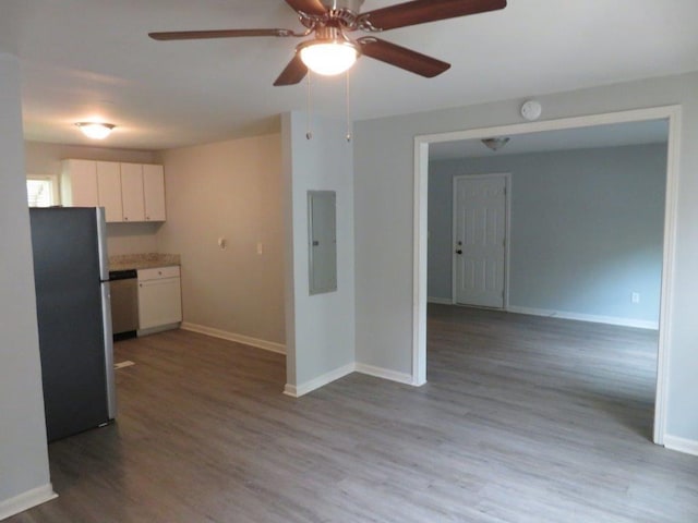 kitchen featuring appliances with stainless steel finishes, white cabinets, light wood-type flooring, electric panel, and ceiling fan