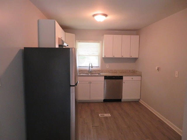 kitchen featuring white cabinetry, stainless steel appliances, wood-type flooring, and sink