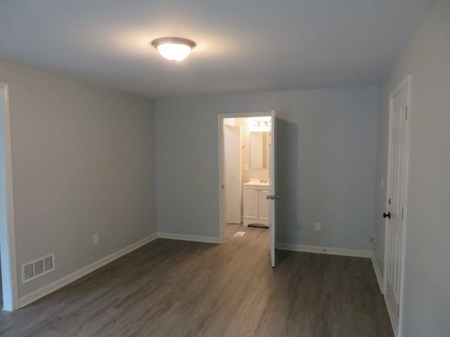 unfurnished room with hardwood / wood-style flooring