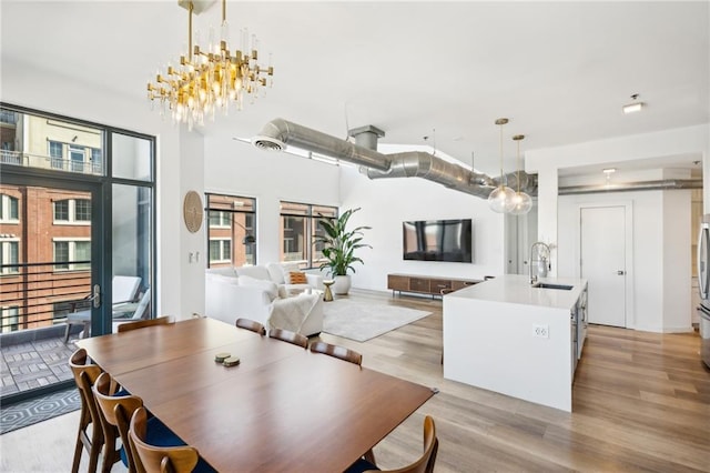 dining space with light hardwood / wood-style floors and sink