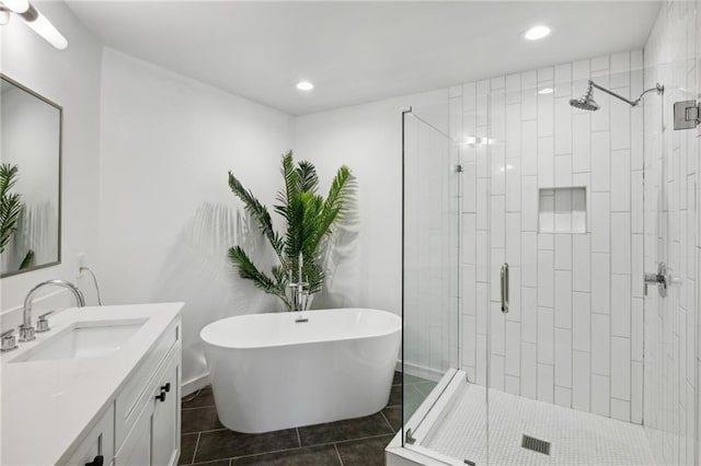 bathroom with tile patterned floors, separate shower and tub, and vanity