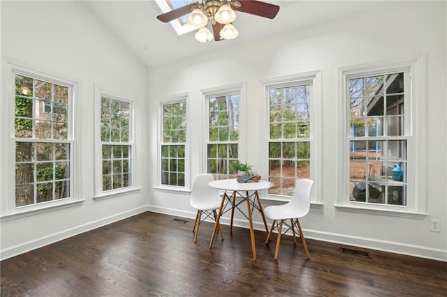 sunroom featuring lofted ceiling with skylight, visible vents, and ceiling fan