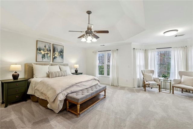 bedroom featuring visible vents, light carpet, and multiple windows