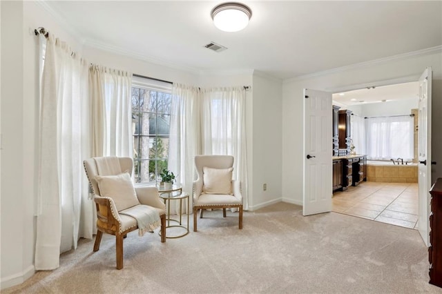 sitting room with ornamental molding, light colored carpet, visible vents, and baseboards