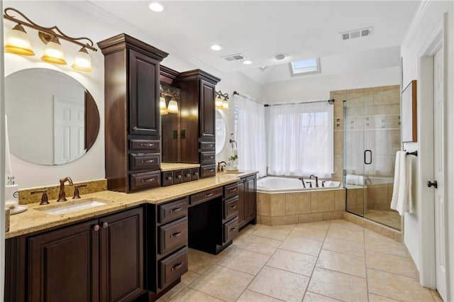 bathroom with a garden tub, a shower stall, visible vents, and a sink