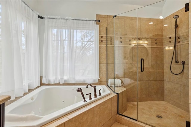 full bath featuring a shower stall and a tub with jets