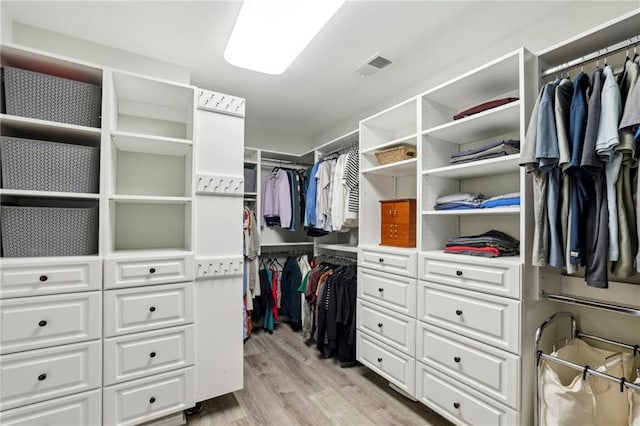 walk in closet featuring visible vents and light wood finished floors