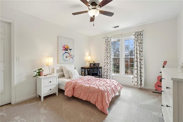 bedroom with a ceiling fan, light colored carpet, visible vents, and baseboards