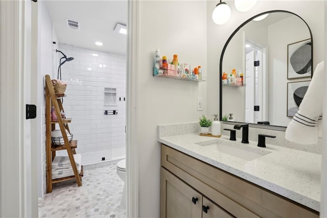 full bathroom with a stall shower, visible vents, toilet, vanity, and recessed lighting