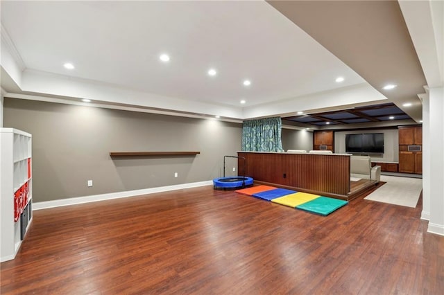 workout area with a baseboard radiator, baseboards, wood finished floors, and recessed lighting