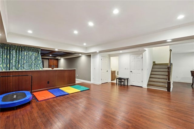 workout room featuring recessed lighting, baseboards, and wood finished floors