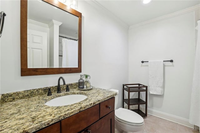 bathroom featuring tile patterned flooring, toilet, vanity, baseboards, and crown molding