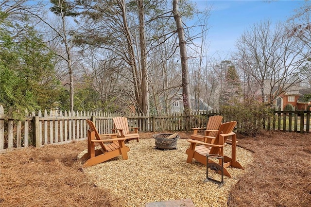 view of yard featuring a fenced backyard and a fire pit