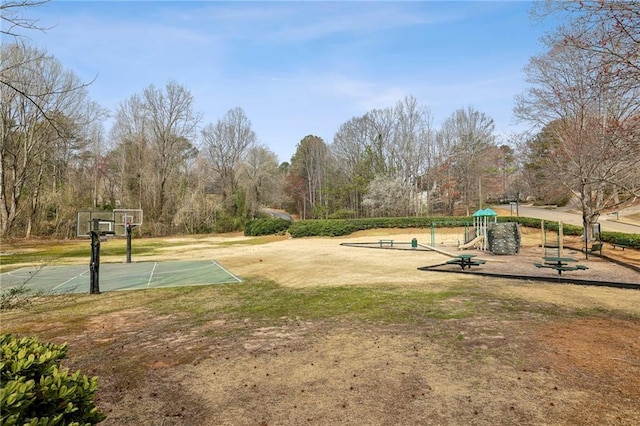 exterior space with community basketball court, playground community, and a yard