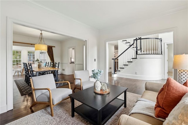 living room featuring stairway, wood finished floors, and crown molding