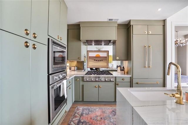 2233 Peachtree Rd NE Unit 1207, Atlanta, GA 30309 - kitchen featuring stainless steel appliances, a sink, gray cabinets, and light wood-style flooring