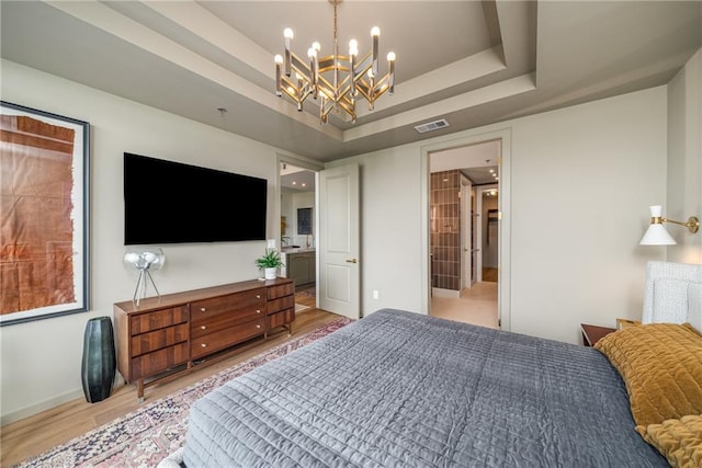 2233 Peachtree Rd NE Unit 1207, Atlanta, GA 30309 - bedroom featuring a chandelier, light wood-style floors, baseboards, and a raised ceiling