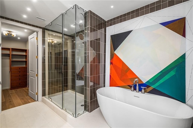 2233 Peachtree Rd NE Unit 1207, Atlanta, GA 30309 - bathroom with a shower stall, recessed lighting, a freestanding bath, tile walls, and wood finished floors