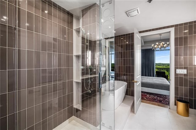 2233 Peachtree Rd NE Unit 1207, Atlanta, GA 30309 - ensuite bathroom featuring tile walls, tile patterned flooring, a freestanding tub, tiled shower, and a chandelier