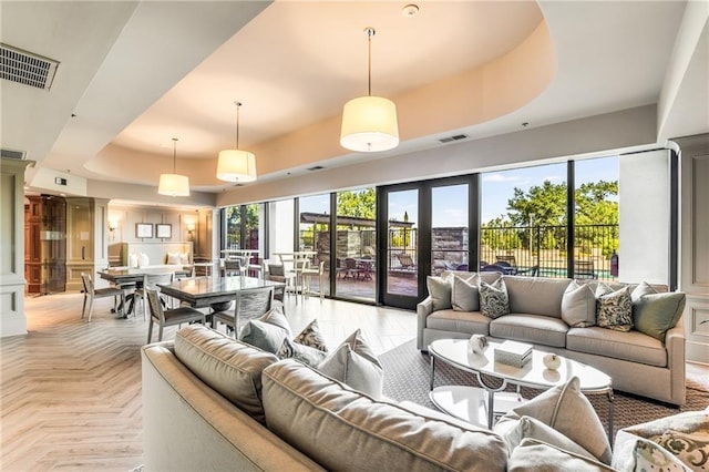 2233 Peachtree Rd NE Unit 1207, Atlanta, GA 30309 - living room featuring a tray ceiling and plenty of natural light