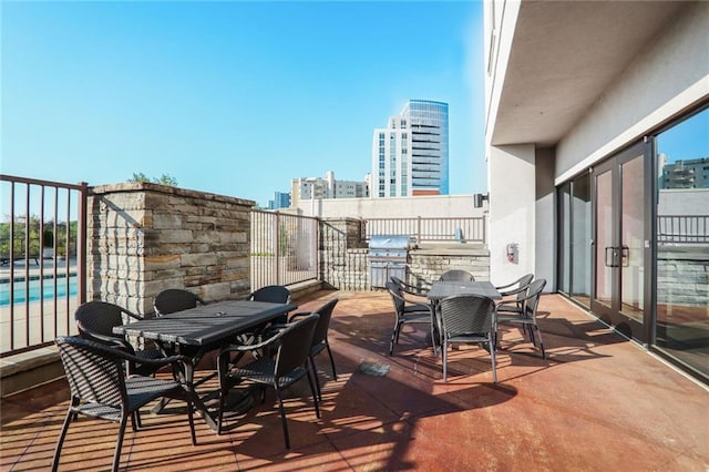 2233 Peachtree Rd NE Unit 1207, Atlanta, GA 30309 - deck featuring outdoor dining area, exterior kitchen, a patio area, an outdoor pool, and area for grilling