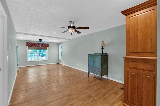 3122 Harmony Rd, Temple, GA 30179 - unfurnished living room featuring a ceiling fan, light wood-style flooring, a textured ceiling, and recessed lighting