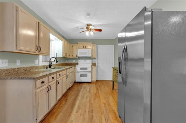 3122 Harmony Rd, Temple, GA 30179 - kitchen with white appliances, ceiling fan, light wood-type flooring, light stone countertops, and light brown cabinetry