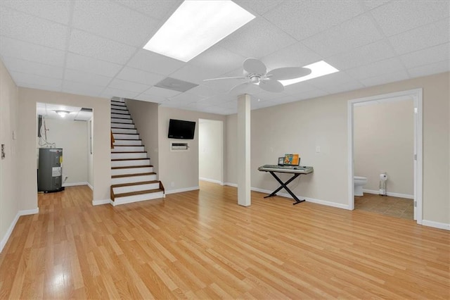 3122 Harmony Rd, Temple, GA 30179 - finished basement featuring water heater, light wood finished floors, stairs, a ceiling fan, and a drop ceiling