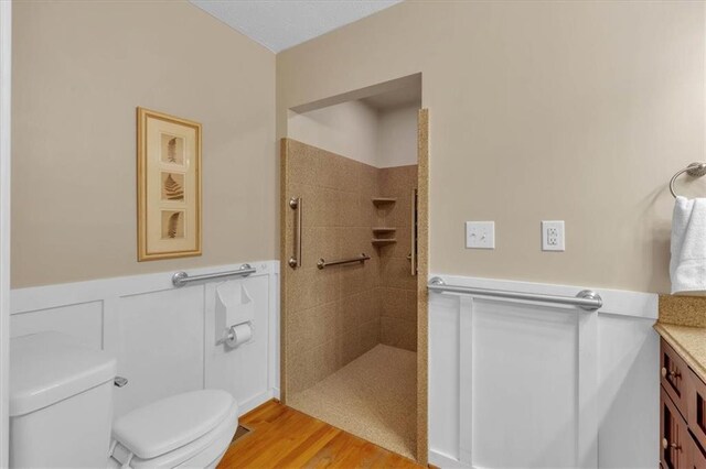 3122 Harmony Rd, Temple, GA 30179 - full bathroom featuring a tile shower, a wainscoted wall, vanity, and wood finished floors