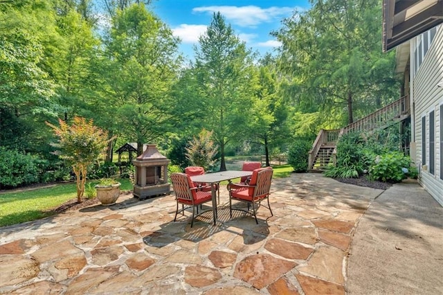 3122 Harmony Rd, Temple, GA 30179 - view of patio with stairway, outdoor dining space, and exterior fireplace